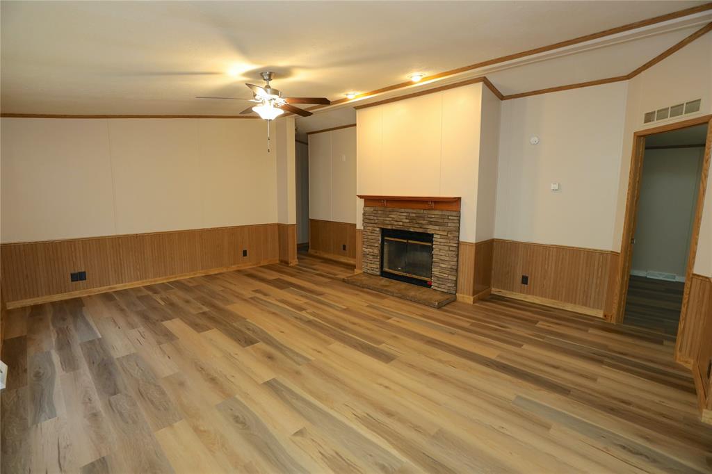 191 Circle Drive Mansfield, LA 71052 - Photo 7 of 22 a view of empty room with a fireplace and wooden floor