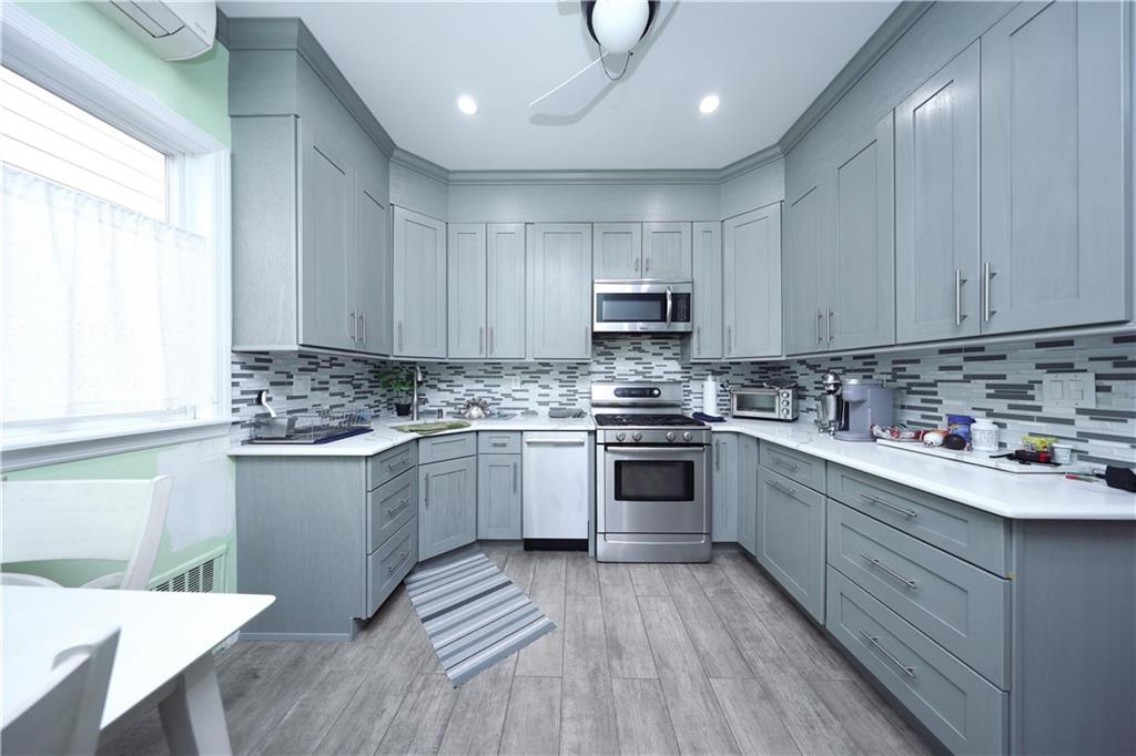 1049 Bay Ridge Parkway Brooklyn, NY 11228 - Photo 14 of 41 a kitchen with kitchen island granite countertop a sink cabinets and wooden floor