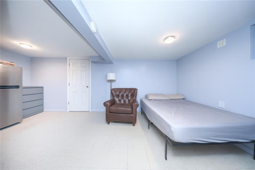 1049 Bay Ridge Parkway Brooklyn, NY 11228 - Photo 17 of 41 a bedroom with a bed and a couch