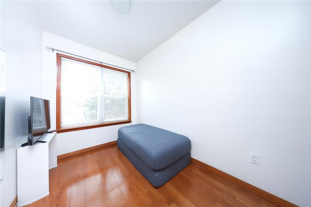 1049 Bay Ridge Parkway Brooklyn, NY 11228 - Photo 18 of 41 a living room with a couch and a window