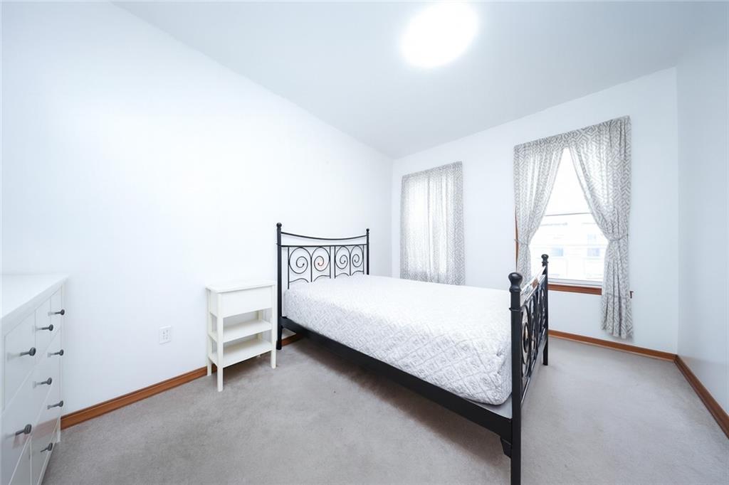1049 Bay Ridge Parkway Brooklyn, NY 11228 - Photo 19 of 41 a bedroom with a bed and a window