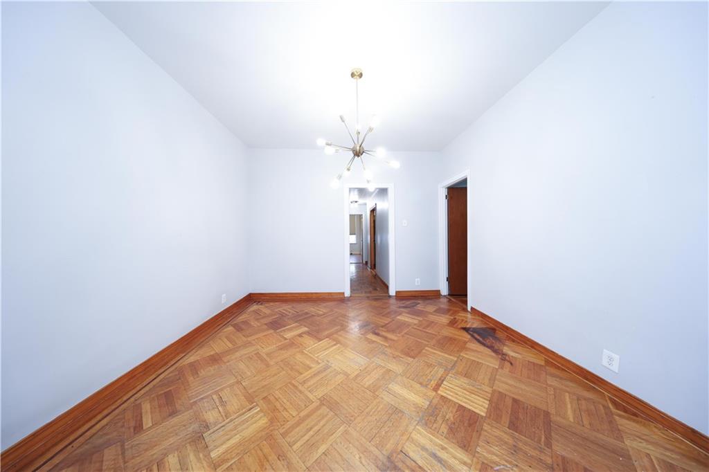 1049 Bay Ridge Parkway Brooklyn, NY 11228 - Photo 24 of 41 a view of empty room with a chandelier fan and wooden floor
