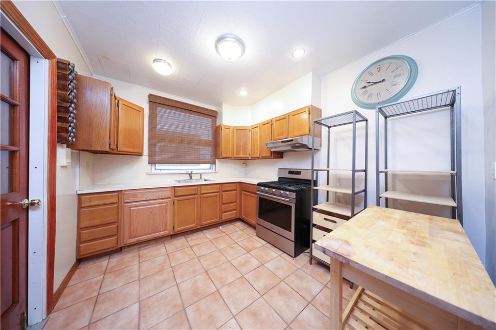 1049 Bay Ridge Parkway Brooklyn, NY 11228 - Photo 25 of 41 a kitchen with stainless steel appliances granite countertop a refrigerator and a stove top oven