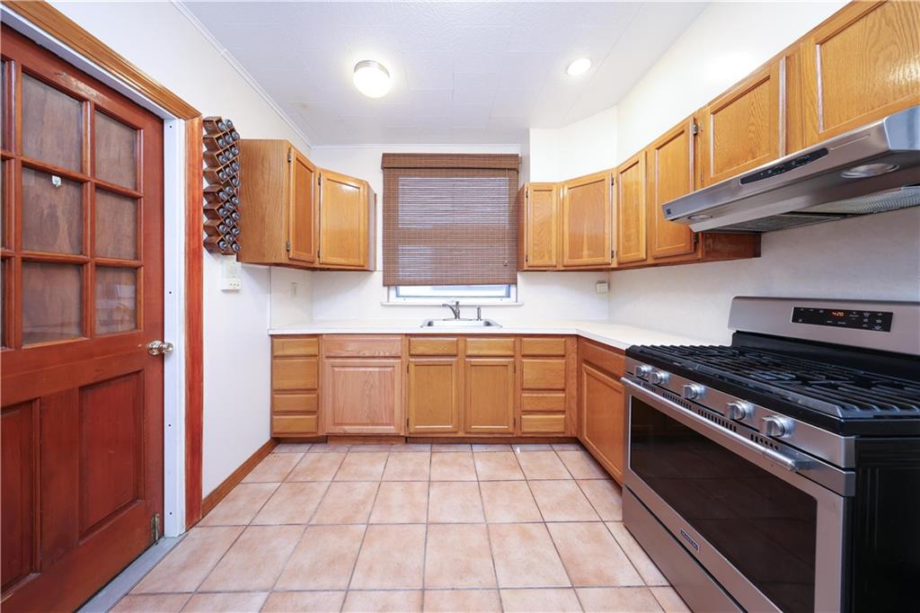 1049 Bay Ridge Parkway Brooklyn, NY 11228 - Photo 26 of 41 a kitchen with stainless steel appliances granite countertop a stove a sink and a microwave
