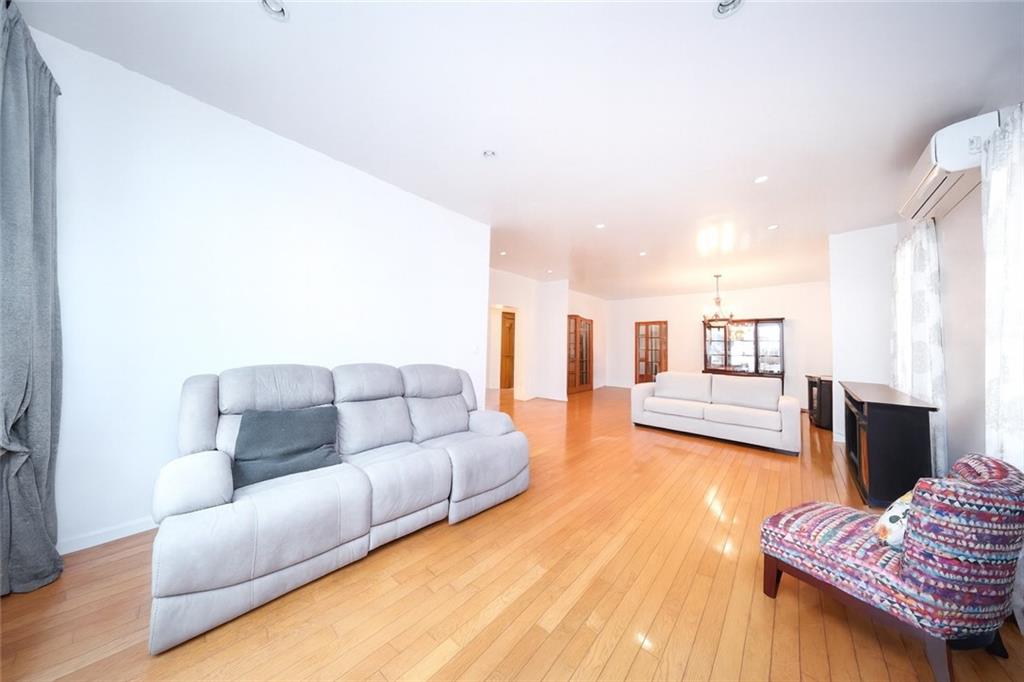 1049 Bay Ridge Parkway Brooklyn, NY 11228 - Photo 7 of 41 a living room with furniture and a wooden floor