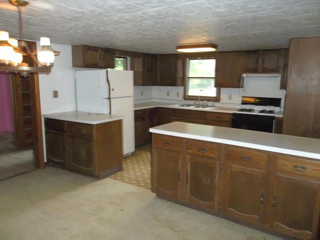 1252 South Ridge Road Oregon, IL 61061 - Photo 3 of 14 a kitchen with stainless steel appliances granite countertop a sink a stove and a refrigerator