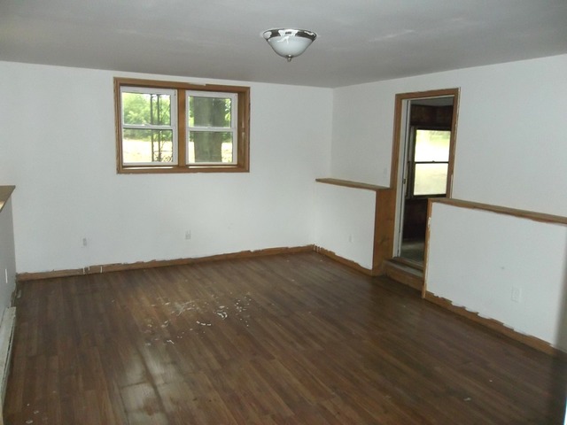 1252 South Ridge Road Oregon, IL 61061 - Photo 7 of 14 a view of empty room with wooden floor and fan
