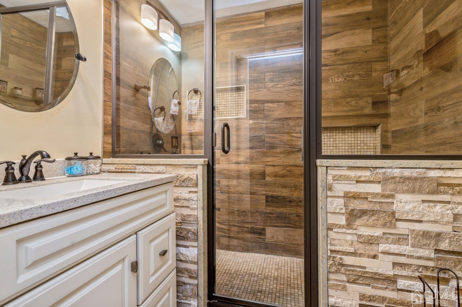 11 Boxwood Road Piscataway, NJ 08854 - Photo 18 of 28 a bathroom with a granite countertop sink a mirror and shower