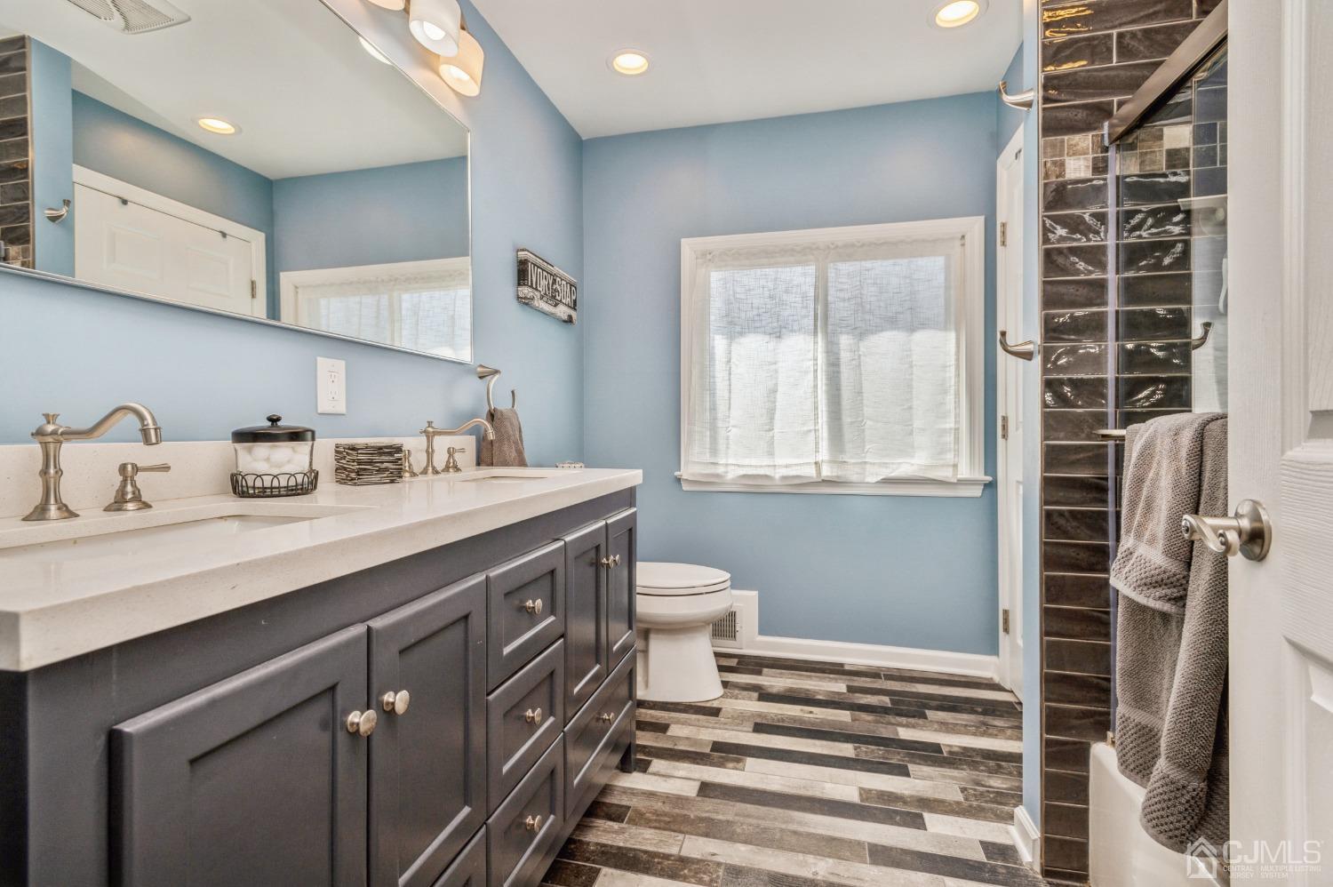 11 Boxwood Road Piscataway, NJ 08854 - Photo 10 of 28 a bathroom with a sink a toilet and shower