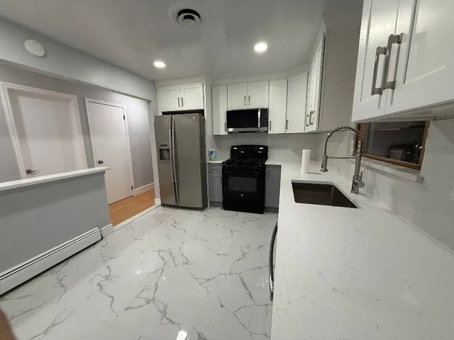 a kitchen with stainless steel appliances a refrigerator stove microwave and sink