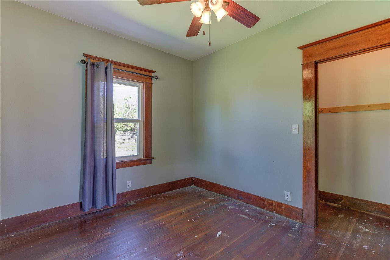 6110 Napa Road Corning, CA 96021 - Photo 36 of 62 an empty room with wooden floor cabinet and windows