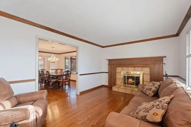 a dining hall with stainless steel appliances a dining table and chairs with wooden floor