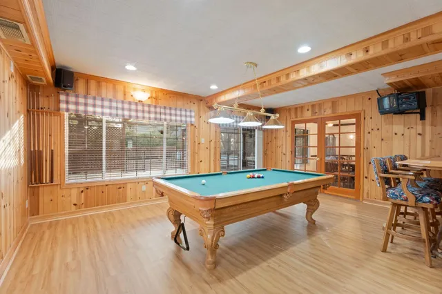 a living room with furniture a fireplace and a large window