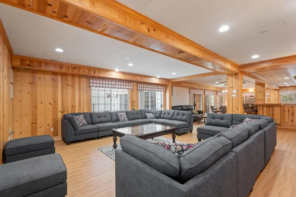 a spacious bedroom with a bed and a chandelier