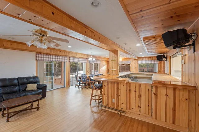 a living room with furniture and a floor to ceiling window
