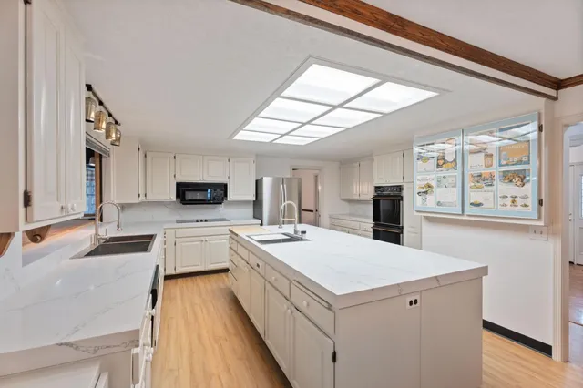 a room with gym equipment and wooden floor