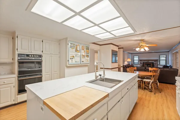 a spacious bathroom with a granite countertop sink and a mirror