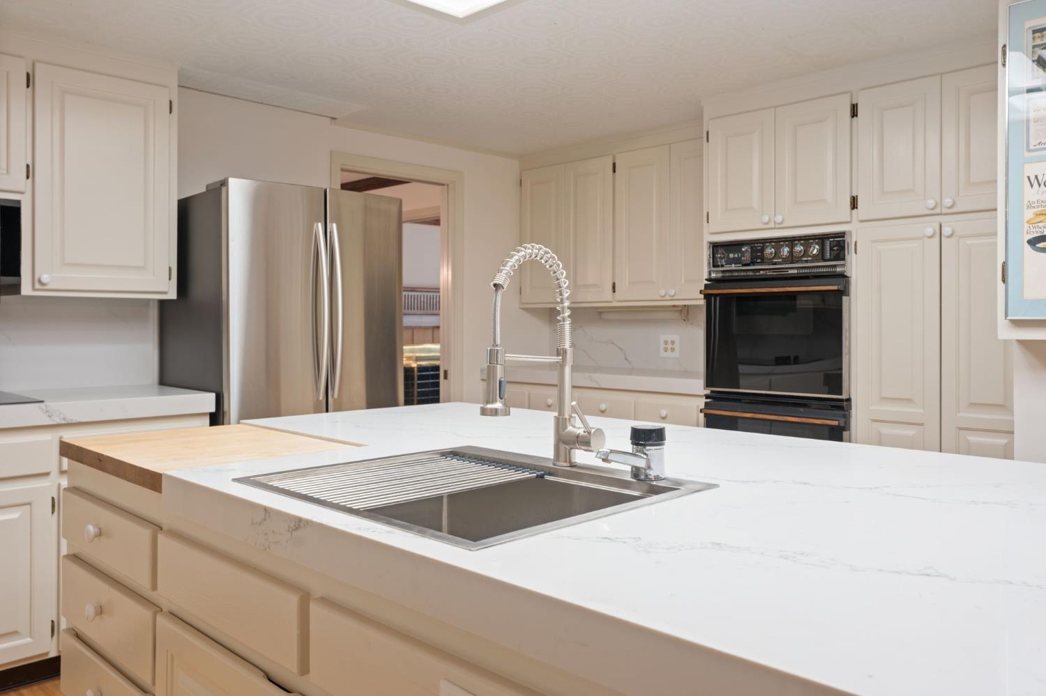 4016 Quartz Drive Santa Rosa, CA 95405 - Photo 30 of 98 a kitchen with granite countertop a refrigerator and a stove