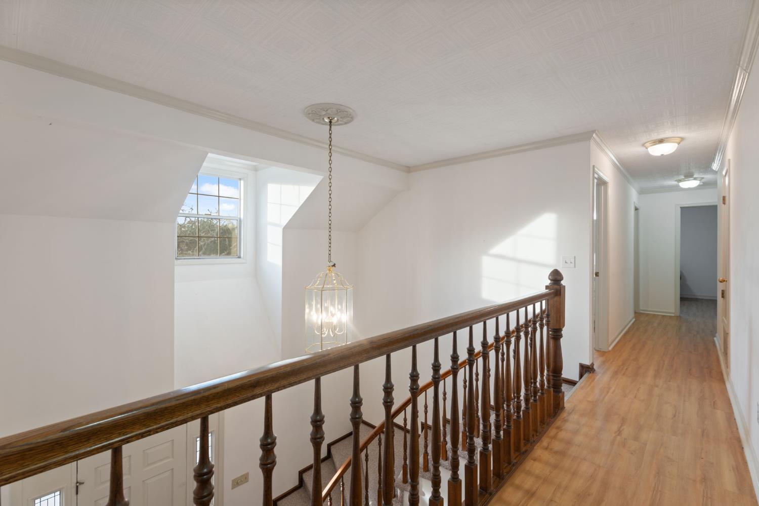 4016 Quartz Drive Santa Rosa, CA 95405 - Photo 58 of 98 a view of a hallway with wooden floor and staircase