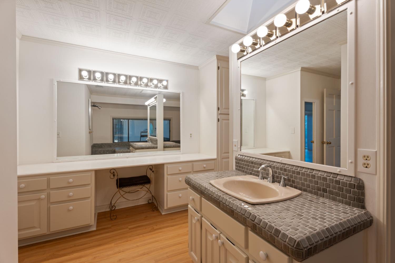 4016 Quartz Drive Santa Rosa, CA 95405 - Photo 67 of 98 a bathroom with a granite countertop sink and a mirror