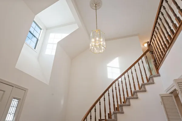 a dining hall with stainless steel appliances a dining table and chairs with wooden floor