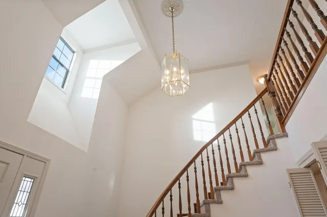 a room with pool table and windows