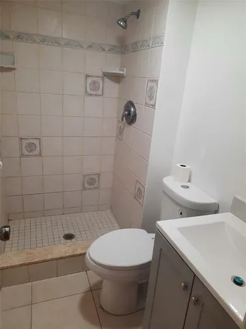 a white toilet sitting next to a bathroom sink
