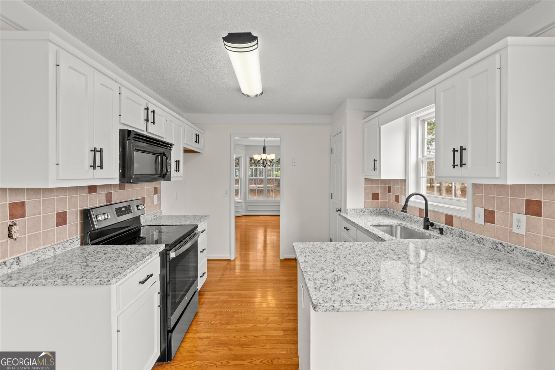 401 Tapley Road Villa Rica, GA 30180 - Photo 14 of 42 a kitchen with stainless steel appliances granite countertop a sink stove and refrigerator