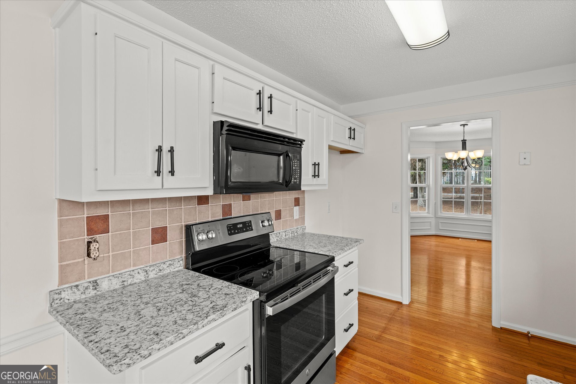 401 Tapley Road Villa Rica, GA 30180 - Photo 17 of 42 a kitchen with stainless steel appliances granite countertop a stove microwave and sink