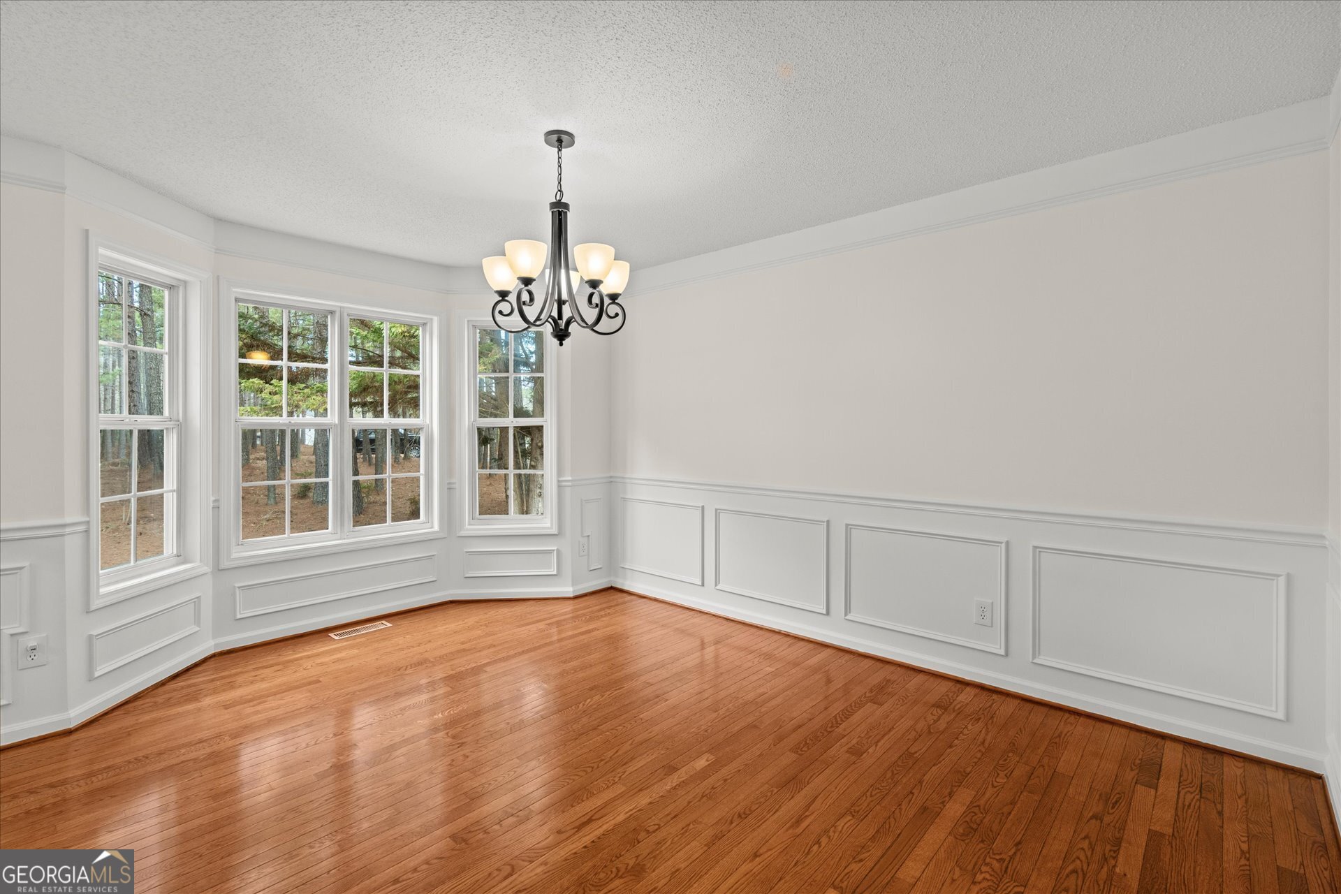 401 Tapley Road Villa Rica, GA 30180 - Photo 19 of 42 a view of an empty room with a window and wooden floor
