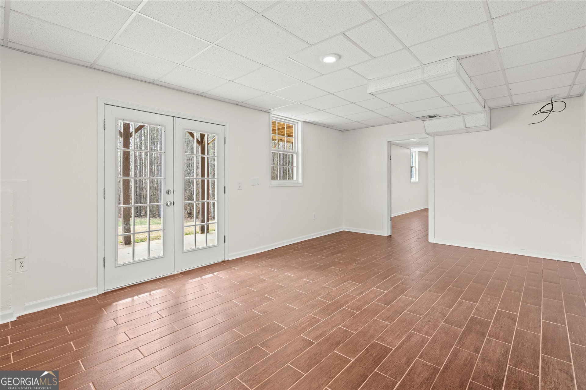 401 Tapley Road Villa Rica, GA 30180 - Photo 30 of 42 a view of an empty room with wooden floor and a window