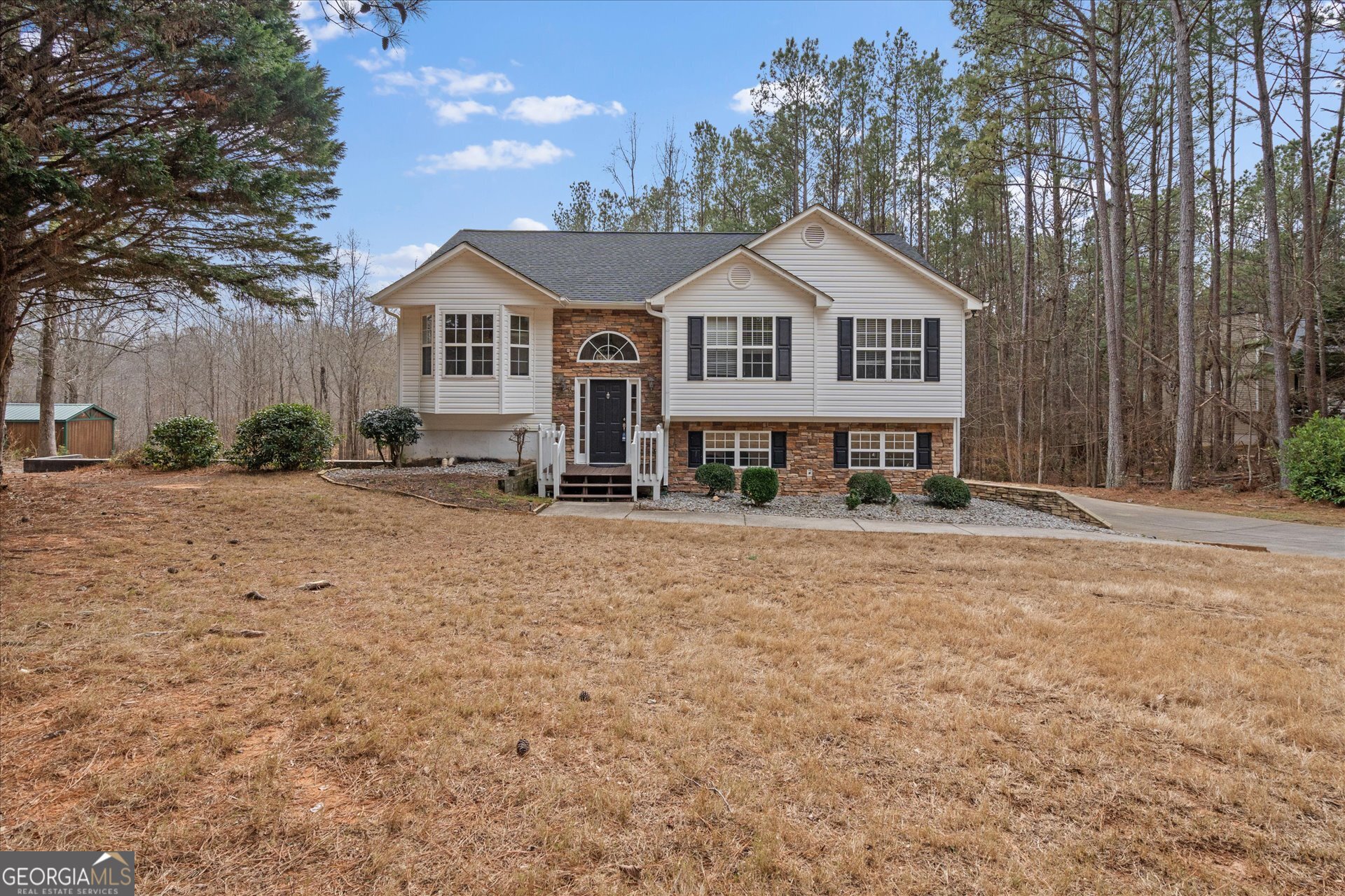 401 Tapley Road Villa Rica, GA 30180 - Photo 3 of 42 a front view of a house with a yard and garage