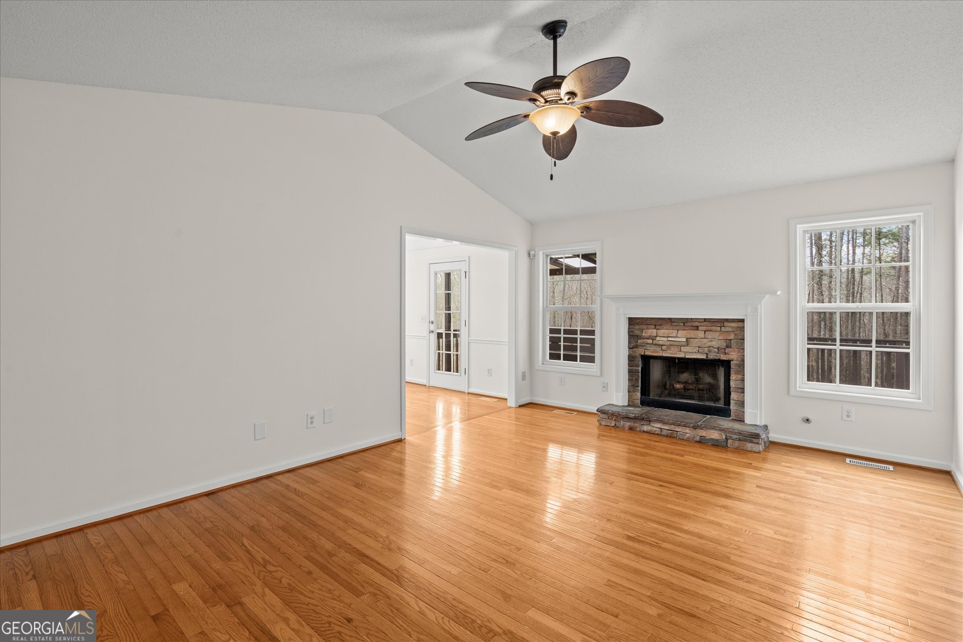 401 Tapley Road Villa Rica, GA 30180 - Photo 9 of 42 a view of an empty room with wooden floor fireplace and a window
