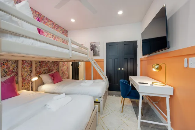 a bedroom with a bed and a table in it