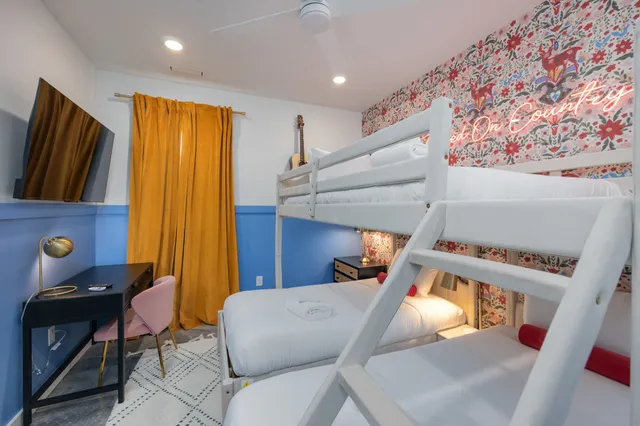 a bedroom with a large bed and dresser