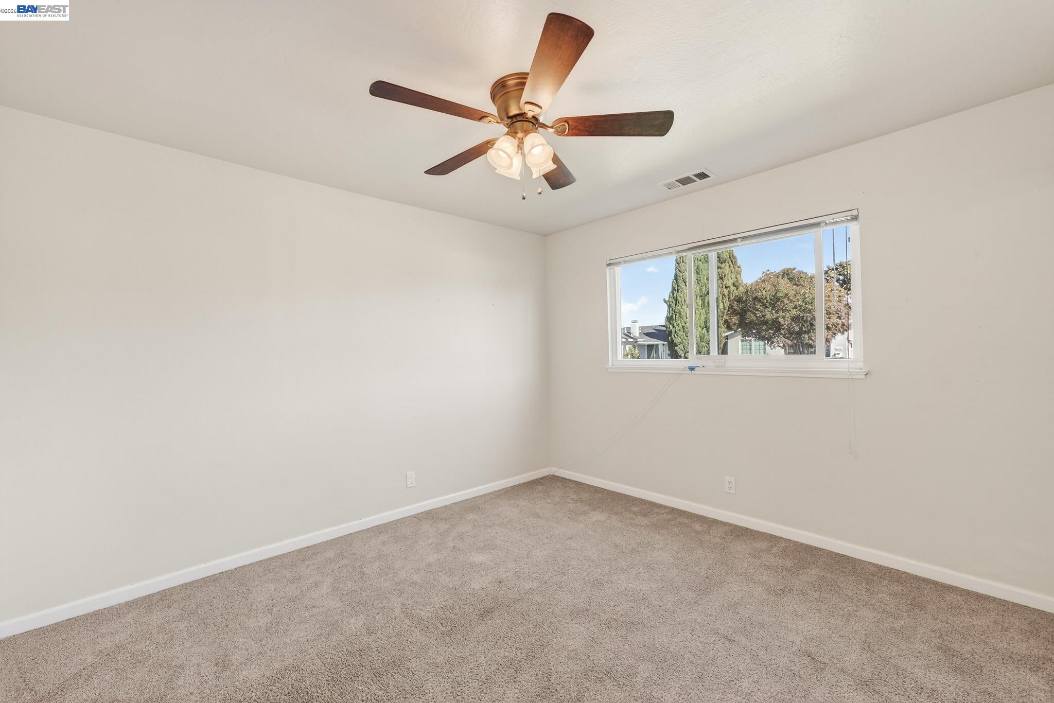 6759 Albyn Court Newark, CA 94560 - Photo 13 of 23 an empty room with a window and a fan
