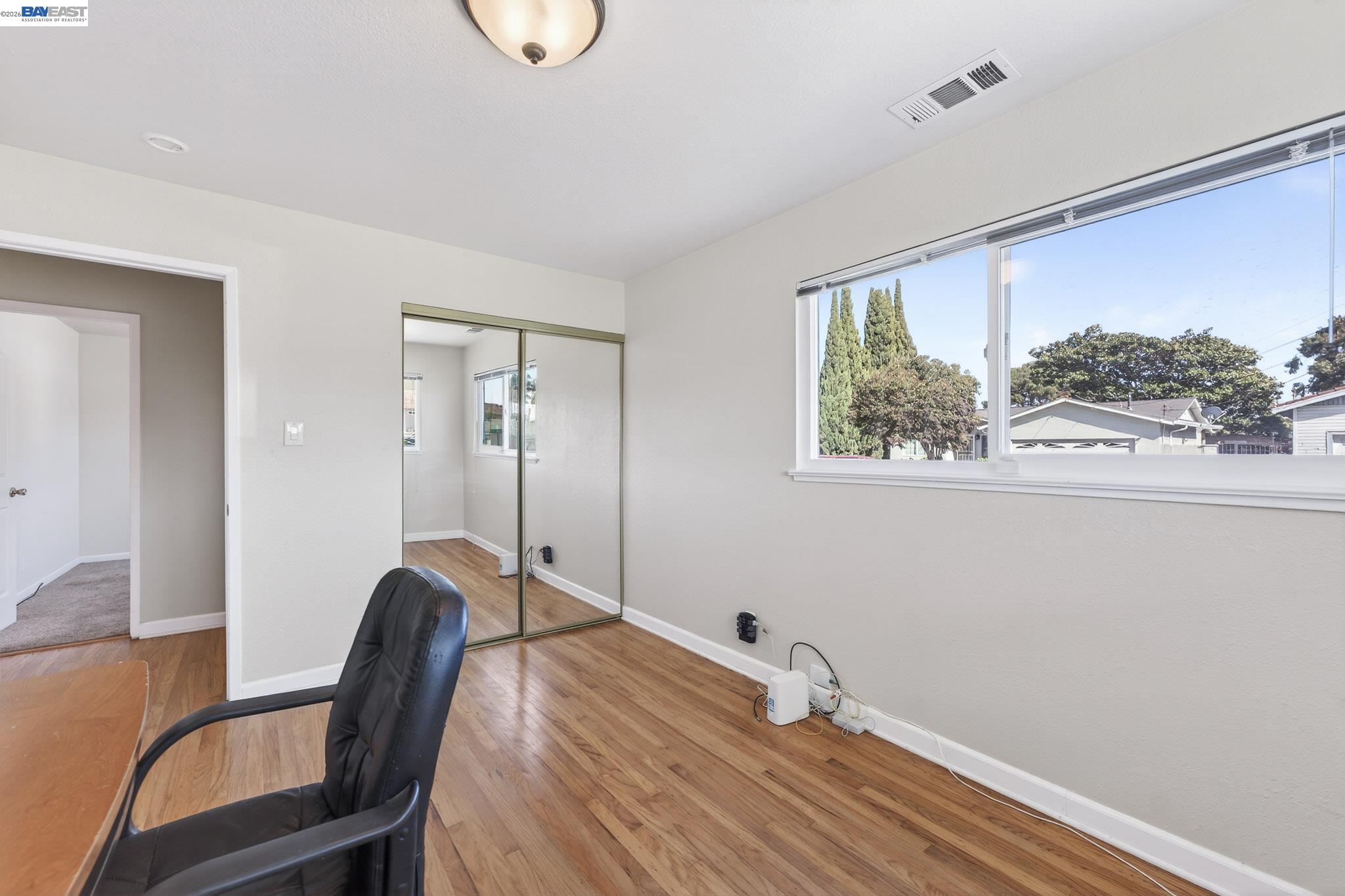 6759 Albyn Court Newark, CA 94560 - Photo 16 of 23 a room with a wooden floor and a chair