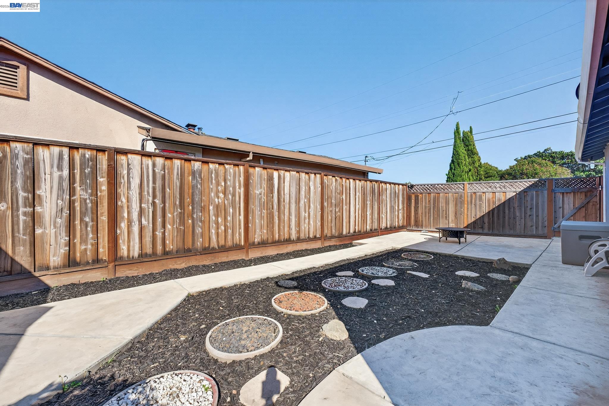 6759 Albyn Court Newark, CA 94560 - Photo 19 of 23 a view of a backyard with table and chairs with wooden fence