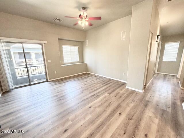 2150 West Alameda Road, Unit 2287 Phoenix, AZ 85085 - Photo 2 of 7 an empty room with wooden floor and windows