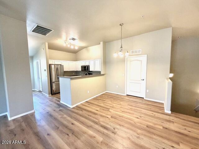 2150 West Alameda Road, Unit 2287 Phoenix, AZ 85085 - Photo 3 of 7 a view of a kitchen with a sink and wooden floor