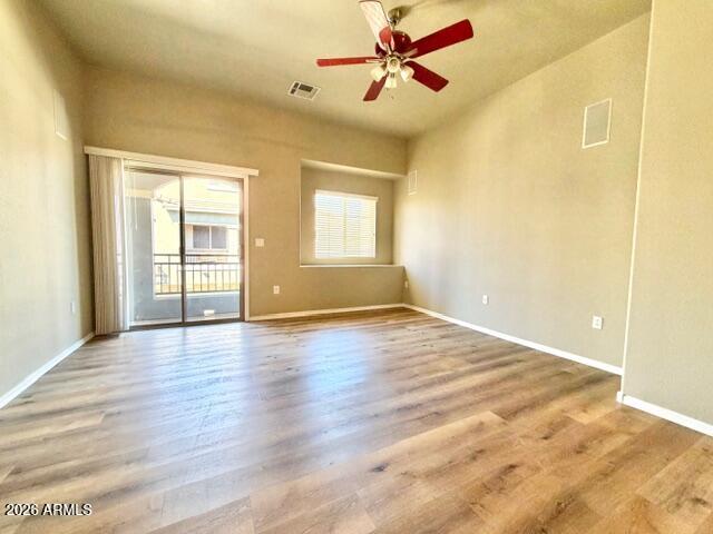 2150 West Alameda Road, Unit 2287 Phoenix, AZ 85085 - Photo 4 of 7 a view of empty room with wooden floor and fan