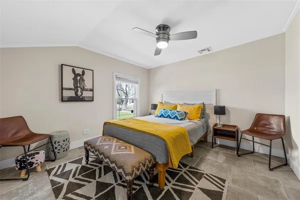 a bedroom with a bed and a chair