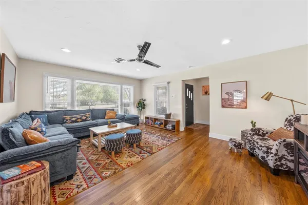 a living room with furniture and wooden floor