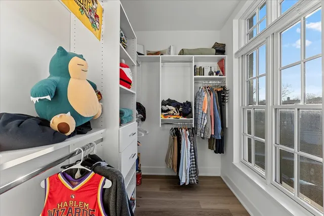 a view of walk in closet with clothes and shoes