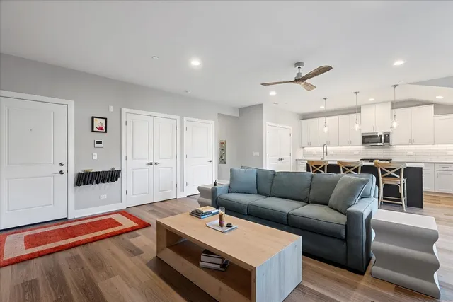 a living room with furniture and kitchen view