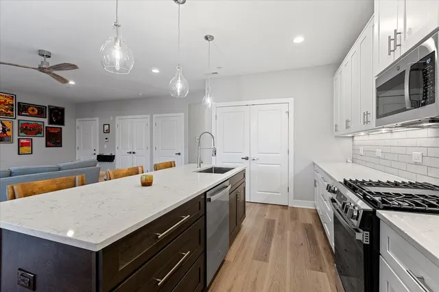 a kitchen with a stove a sink and a refrigerator