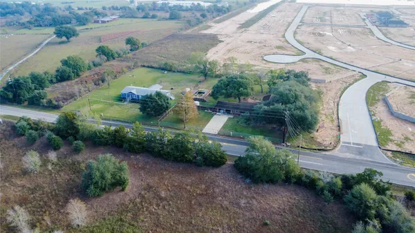 an aerial view of a house with garden space and lake view