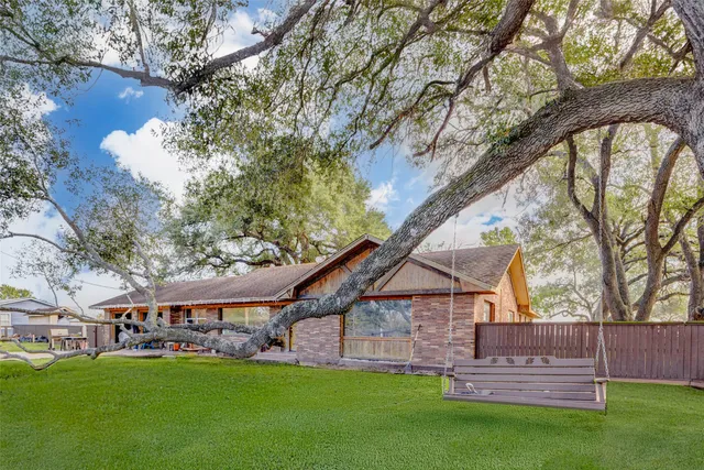 a view of a house with patio and a garden