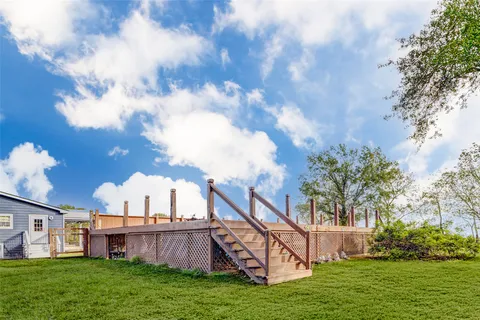 a white house with a big yard and trees