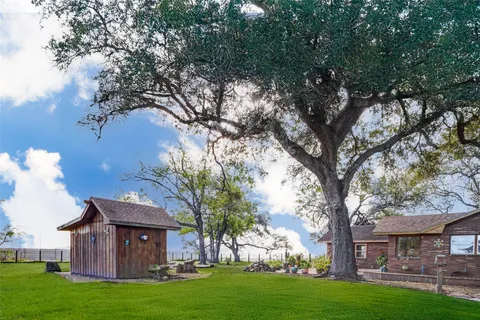 a backyard of a house with table and chairs